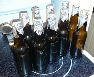 Bottles ready for oven sanitizing with aluminum foil caps